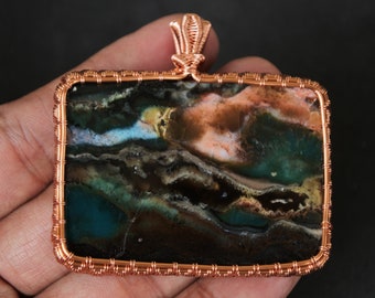 Scenic Opalized Petrified Wood Set In Wire Wrapped Copper Pendant