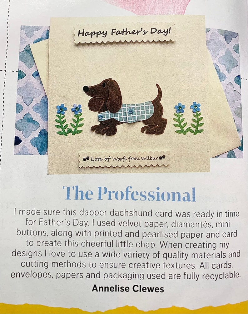 May include: A handmade card featuring a brown dachshund wearing a blue and white checked shirt. The card has a blue and white floral design and the text "Happy Father's Day!" and "Lots of woofs from Wilbur".