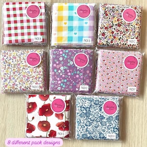 May include: Eight different fabric packs featuring a variety of floral and geometric designs. Each pack is labelled with a letter from A to H. The packs are arranged in two rows of four. The fabric is a mix of red, white, blue, pink, yellow, and purple.
