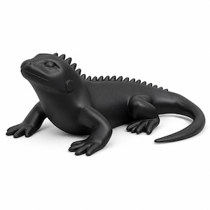May include: A matte black figurine of an iguana in a resting position. The lizard features a row of small spikes running along its back from the head to the tail, four legs with visible toes, and a smooth, solid-colored surface throughout.