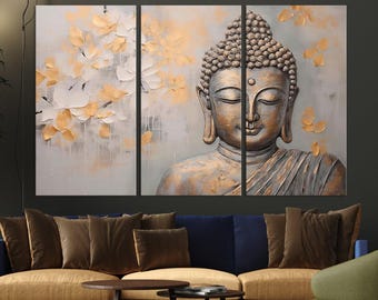 May include: A three-piece canvas print set featuring a golden Buddha statue with a serene expression. The background is a soft gray with delicate white and gold floral patterns.