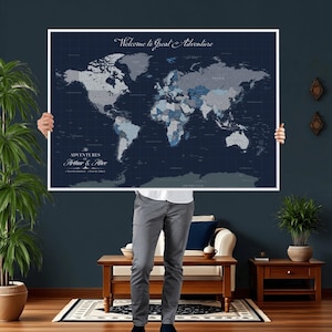 May include: A large world map print with a navy blue background and a white border. The map features a detailed depiction of the continents in shades of gray and blue. The text "Welcome to Great Adventure" is at the top, and "The Adventures of Arthur & Alice" is at the bottom.