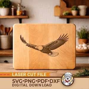 May include: A light-colored wooden cutting board with a detailed engraving of an eagle in flight. The text "LASER CUT FILE" and "SVG•PNG•PDF•DXF DIGITAL DOWNLOAD" are displayed at the bottom. A cartoon cat chef logo is in the bottom right corner.
