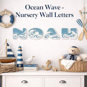 May include: White wall letters spelling "NOAH" with a blue ocean wave design. The letters are part of a nursery wall decor set. The image also includes nautical-themed decorations like a sailboat, lighthouse, and teddy bear.