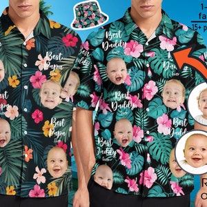 Könnte beinhalten: Ein schwarzes und grünes Hawaiihemd mit tropischem Muster mit rosa Blumen, grünen Blättern und mehreren Kindergesichtern. Das Hemd hat einen Knopfkrag und kurze Ärmel. Der Text "Best Daddy Ever" ist auf dem Hemd aufgedruckt.