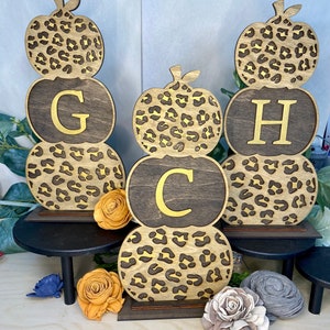 Wooden Personalized Leopard print pumpkin stack.  Comes with stand. Accents of gold hand painted
