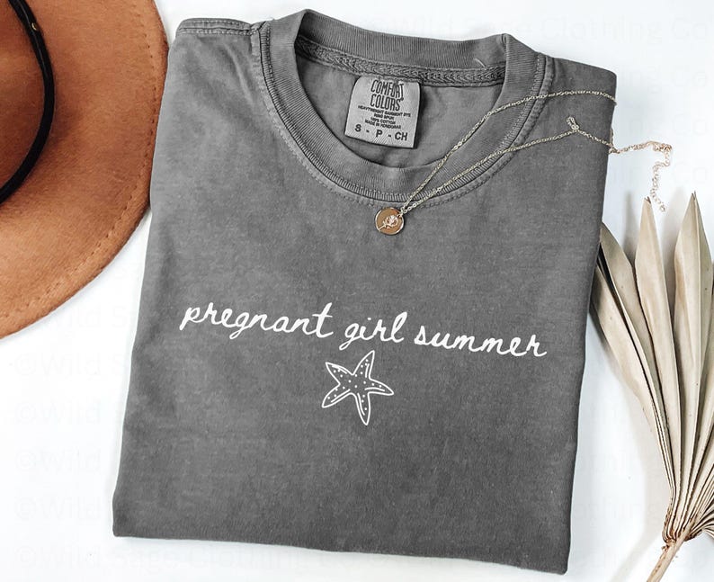 May include: A gray t-shirt with the text "pregnant girl summer" and a white starfish graphic.