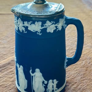 Antique rare Wedgwood Jasperware syrup pitcher with magnificent classical figured motif on a deep cobalt blue.