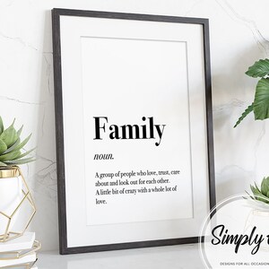 May include: Black and white printable wall art with the word "Family" defined as a group of people who love, trust, care about, and look out for each other. The definition also states that family is a little bit of crazy with a whole lot of love. The text is in a simple font and is centered on the page. The bottom right corner of the page has the text "Simply" in a cursive font.