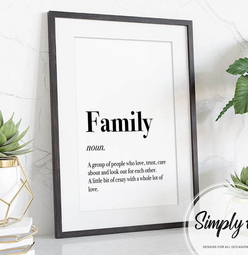 May include: Black and white printable wall art with the word "Family" defined as a group of people who love, trust, care about, and look out for each other. The definition also states that family is a little bit of crazy with a whole lot of love. The text is in a simple font and is centered on the page. The bottom right corner of the page has the text "Simply" in a cursive font.