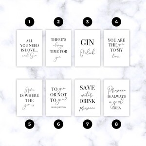 May include: Eight rectangular white prints featuring black typography with gin and prosecco themed quotes. The prints are numbered one through eight and display phrases such as All You Need Is Love and Gin, Gin O'clock, and Prosecco Is Always A Good Idea.
