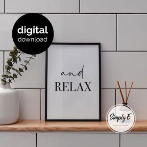 May include: A black framed wall art print featuring the text and RELAX in a combination of script and serif fonts on a white background. A black circular badge in the upper left corner contains the white text digital download.