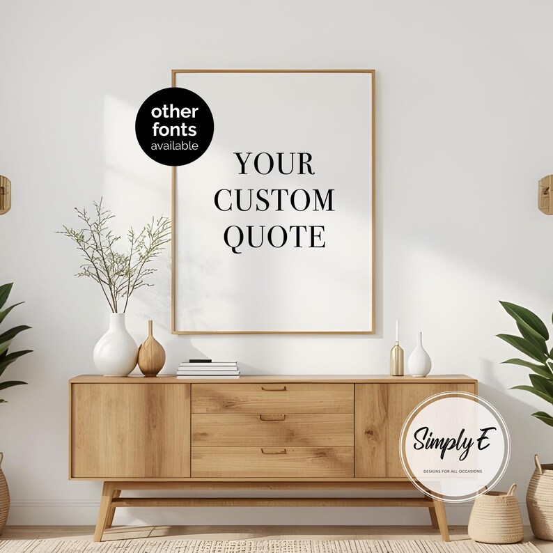 K&ouml;nnte beinhalten: Ein gerahmter Druck mit dem Text "YOUR CUSTOM QUOTE" in einer modernen Schriftart. Der Druck wird &uuml;ber einem Holzschrank mit Schubladen und dekorativen Vasen angezeigt. Das Bild enth&auml;lt den Text "other fonts available" und das Logo von "Simply E Designs for all Occasions."