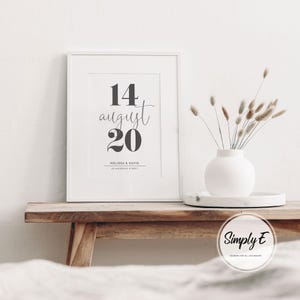 May include: A white ceramic mug with a black handle and the text "But First, Coffee" in a black, bold font. The mug is on a white surface.