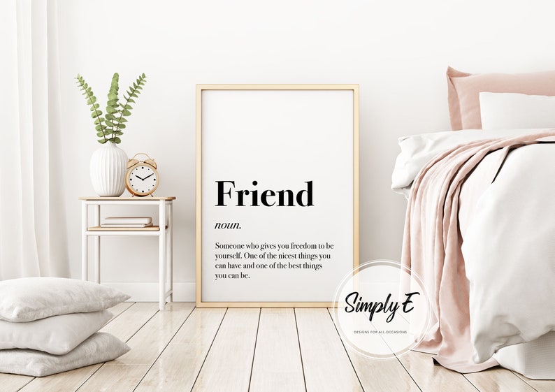 May include: A framed print with the definition of "Friend" in black text on a white background. The definition reads: "Someone who gives you freedom to be yourself. One of the nicest things you can have and one of the best things you can be."