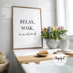 May include: A white ceramic mug with a black handle and the text "But First, Coffee" in a handwritten style. The mug is on a white surface.