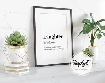 Peut inclure: Impression encadrée en noir avec la définition de "Rire" en texte noir. L'impression est présentée sur une surface blanche avec des plantes décoratives dans des pots blancs et dorés. Le logo Simply E est inclus.