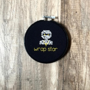 Glow in the Dark Wrap Star Wall Hanging, Glow in the dark decorations, funny Halloween Decor, Spooky Cross Stitch, Mummy Puns