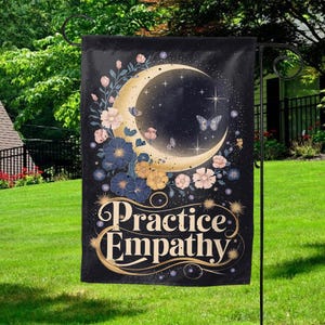 May include: A black garden flag with a crescent moon and stars, surrounded by flowers and butterflies. The text "Practice Empathy" is written in gold lettering.