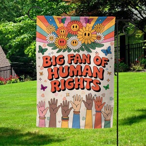 May include: A garden flag with the text "BIG FAN OF HUMAN RIGHTS" in orange, with a retro flower and butterfly design. The flag features a diverse group of hands raised in solidarity, set against a beige background.