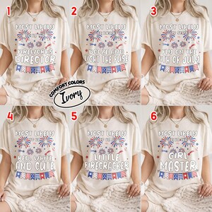 May include: Six ivory t-shirts featuring red and blue firework graphics and bunting banners. Each shirt displays unique text: Most Likely To Be The Fireworks Director, Booze And Light The Fuse, Stay Fly On The 4th Of July, Red, White And Cute, A Little Firecracker, or Girl Master.