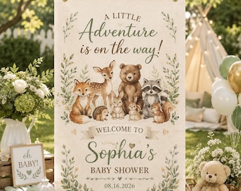 May include: A rectangular fabric banner featuring the text A LITTLE Adventure is on the way! and WELCOME TO Sophia's BABY SHOWER 08.16.2026. The design includes illustrations of a fox, deer, hedgehog, bear, rabbit, and raccoon surrounded by greenery.