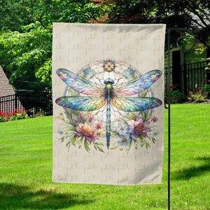 May include: A garden flag featuring a colorful dragonfly design. The dragonfly has iridescent wings and is surrounded by flowers and a stained-glass style background. The flag is beige and is hanging on a black metal stand.