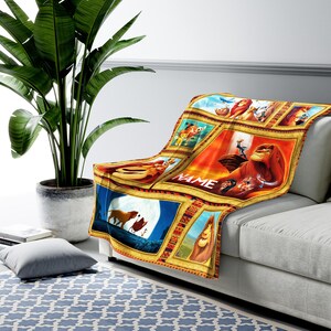 May include: A colorful throw blanket featuring a collage of images from the Disney movie The Lion King. The blanket is made of soft fleece and is perfect for snuggling up on the couch. The blanket features Simba, Mufasa, Nala, and other characters from the movie. The blanket is personalized with the name "NAME" in a gold frame.