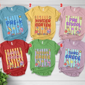 May include: Six short-sleeve t-shirts in blue, yellow, pink, red, green, and purple. Each shirt features a graphic with vertical stripes, a pencil, an apple, a backpack, a star, and text reading Pre-K, Kindergarten, Preschool, First Grade, Second Grade, or Third Grade, with Mrs. Alice printed below.