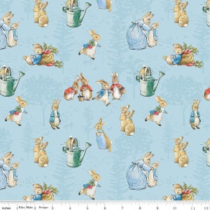 May include: A blue fabric with a repeating pattern of Peter Rabbit characters. The characters are in various poses, including holding carrots, watering cans, and baskets. The background is a light blue with a subtle pattern of trees and leaves.