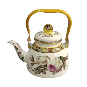 May include: White enamel teapot with a yellow handle and lid. The teapot is decorated with pink and white roses and green leaves. Gold trim accents the lid and base. The teapot has a spout and a curved handle.