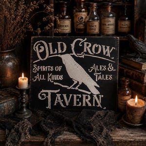 May include: A rectangular black wooden sign featuring white painted text and a crow illustration. The sign reads Old Crow Tavern, Spirits of All Kinds, Ales & Tales. The lettering and crow graphic are in a distressed, weathered white finish.