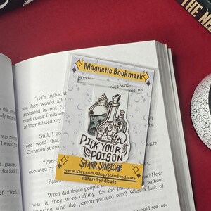 May include: A black and white illustration of a potion bottle with a skull and crossbones. The illustration is on a white background with a yellow border. The text "Pick Your Poison" is written in black letters on a yellow background. The text "Starr Syndicate" is written in black letters on a white background. The text "www.Etsy.com/Shop/StarrSyndicate" is written in black letters on a white background. The text "@Starr.Syndicate" is written in black letters on a white background.