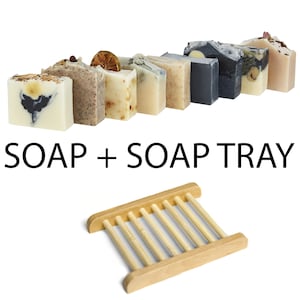May include: A set of nine different scented soaps with a wooden soap dish. The soaps are arranged in a row and are all different colours and shapes. The soap dish is made of natural wood and has a simple design.