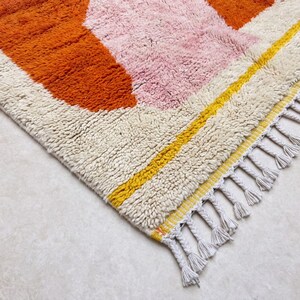 Cozy bedroom styled with a soft orange Berber rug bringing warmth and comfort to the space