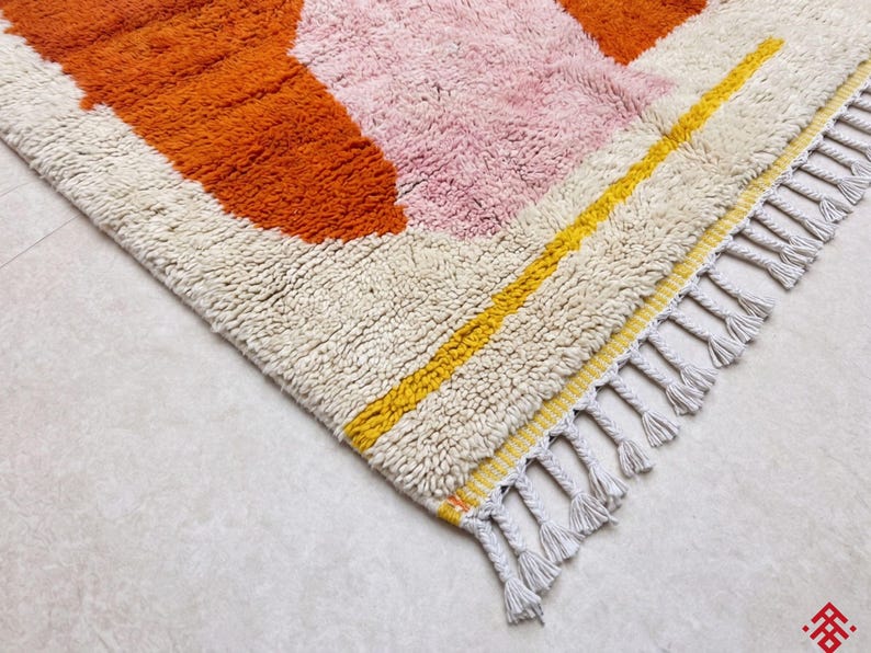 Cozy bedroom styled with a soft orange Berber rug bringing warmth and comfort to the space
