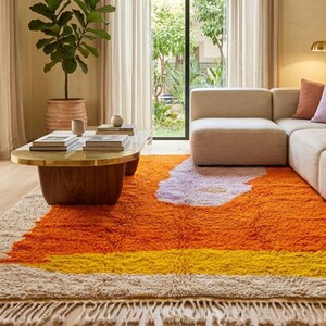 Close up of orange Moroccan wool rug showing thick plush fibers and handcrafted texture details