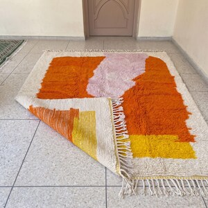 Handmade Moroccan rug with deep orange tones and organic abstract design enhancing modern decor