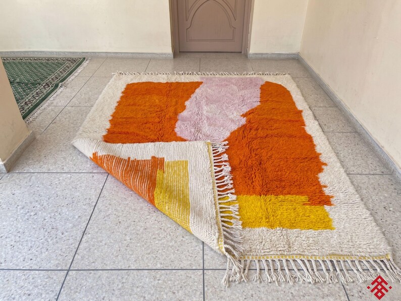 Handmade Moroccan rug with deep orange tones and organic abstract design enhancing modern decor