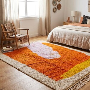 Vibrant orange Moroccan area rug with high pile wool texture styled in a mid century modern interior