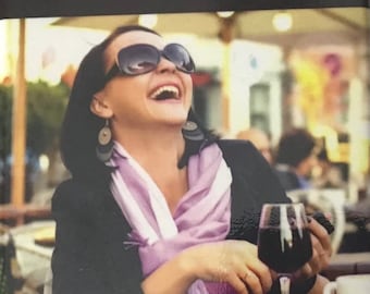 May include: A humorous image with a woman laughing and holding a glass of red wine. The text reads "A day without wine is like... Just kidding, I have no idea."