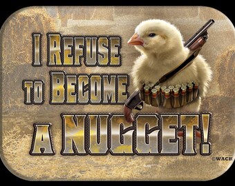 May include: A humorous graphic features a fluffy yellow chick armed with a shotgun and ammunition. Text reads "I REFUSE TO BECOME A NUGGET!" The background has a rustic, hay-like texture, with a black border.