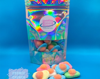 May include: A bag of freeze-dried sweets shaped like eggs. The sweets are blue, green, and pink with white frosting. The bag is iridescent and has a logo that says "Cosmic Crunch Freeze Dried Treats".