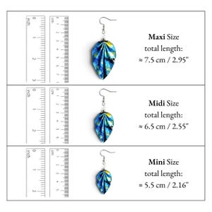 May include: Three leaf-shaped earrings with blue, yellow, and black patterns. The Maxi size is 2.95 inches, Midi is 2.55 inches, and Mini is 2.16 inches long. Each earring features a silver-toned hook and a folded, petal-like design.