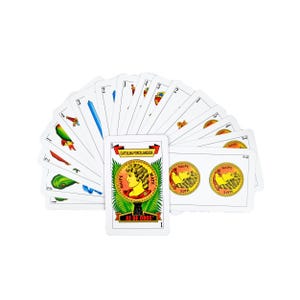 May include: A deck of playing cards fanned out on a white surface. The cards feature various suits and numbers, with a central card displaying the text "AS DE OROS" and a portrait. The cards are white with colorful illustrations.
