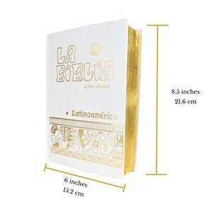 May include: White hardcover book with gold lettering and a gold border. The title is "La Biblia Letra Grande" and the subtitle is "Latinoam&eacute;rica". The book measures 6 inches by 8.5 inches.