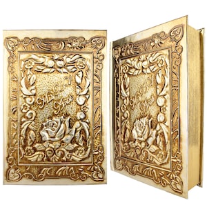 May include: Two gold-colored boxes with ornate floral designs and the text "Mis 901 Años" embossed on the front.
