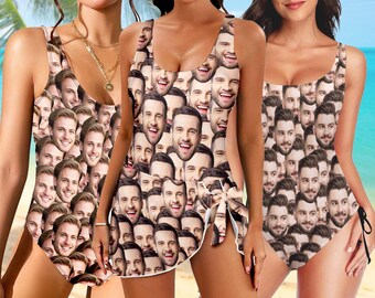 May include: Three swimsuits, each with a repeating pattern of smiling faces. The swimsuits are in different styles: a one-piece, a tankini with a side tie, and a one-piece with adjustable straps. The background is a beach scene.