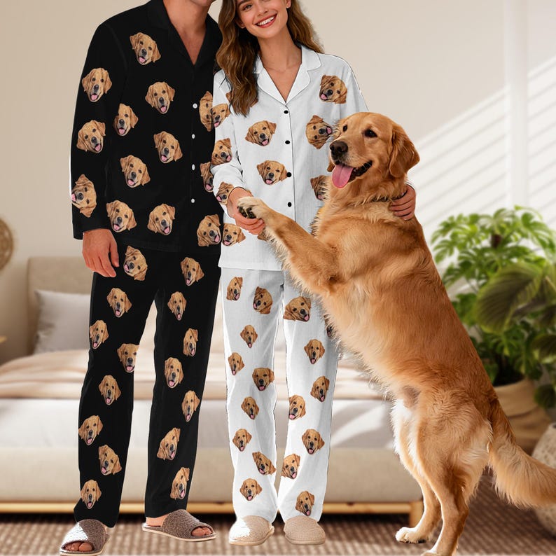 May include: A set of two-piece pyjamas featuring a repeating pattern of golden retriever faces. One set is black with white buttons and a collared top, while the other set is white with black buttons and a collared top, both with matching trousers.