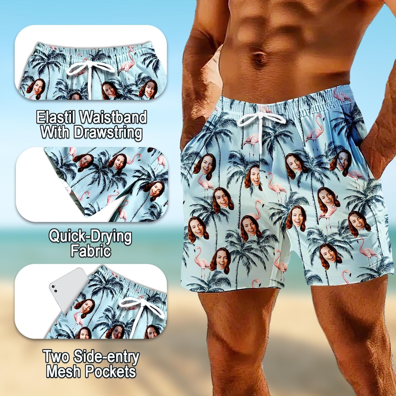May include: Light blue swim shorts featuring a repeating pattern of palm trees, pink flamingos, and a woman's face. The shorts include an elastic waistband with a white drawstring, quick-drying fabric, and two side-entry mesh pockets.